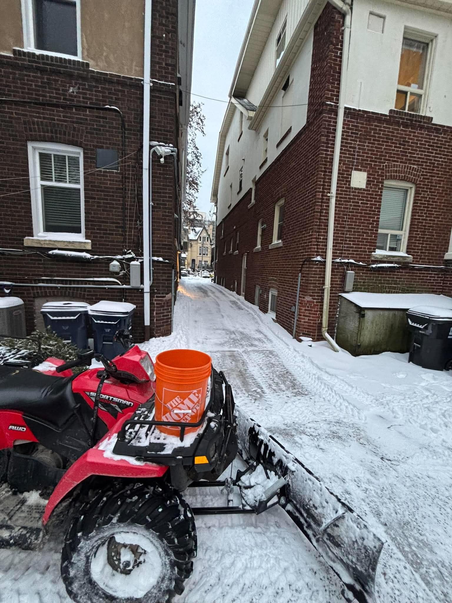 Crew hand-shovelling a narrow side path